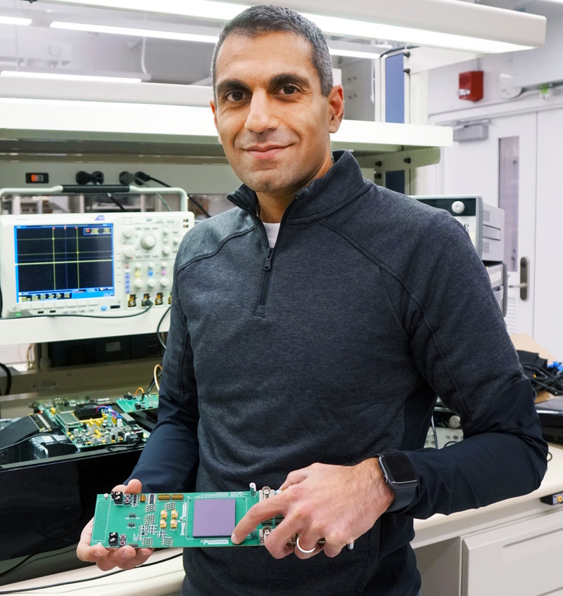 Naveen Verma, Co-Founder and CEO of EnCharge AI, holds a prototype of the company's advanced computing technology in his laboratory at Princeton University.